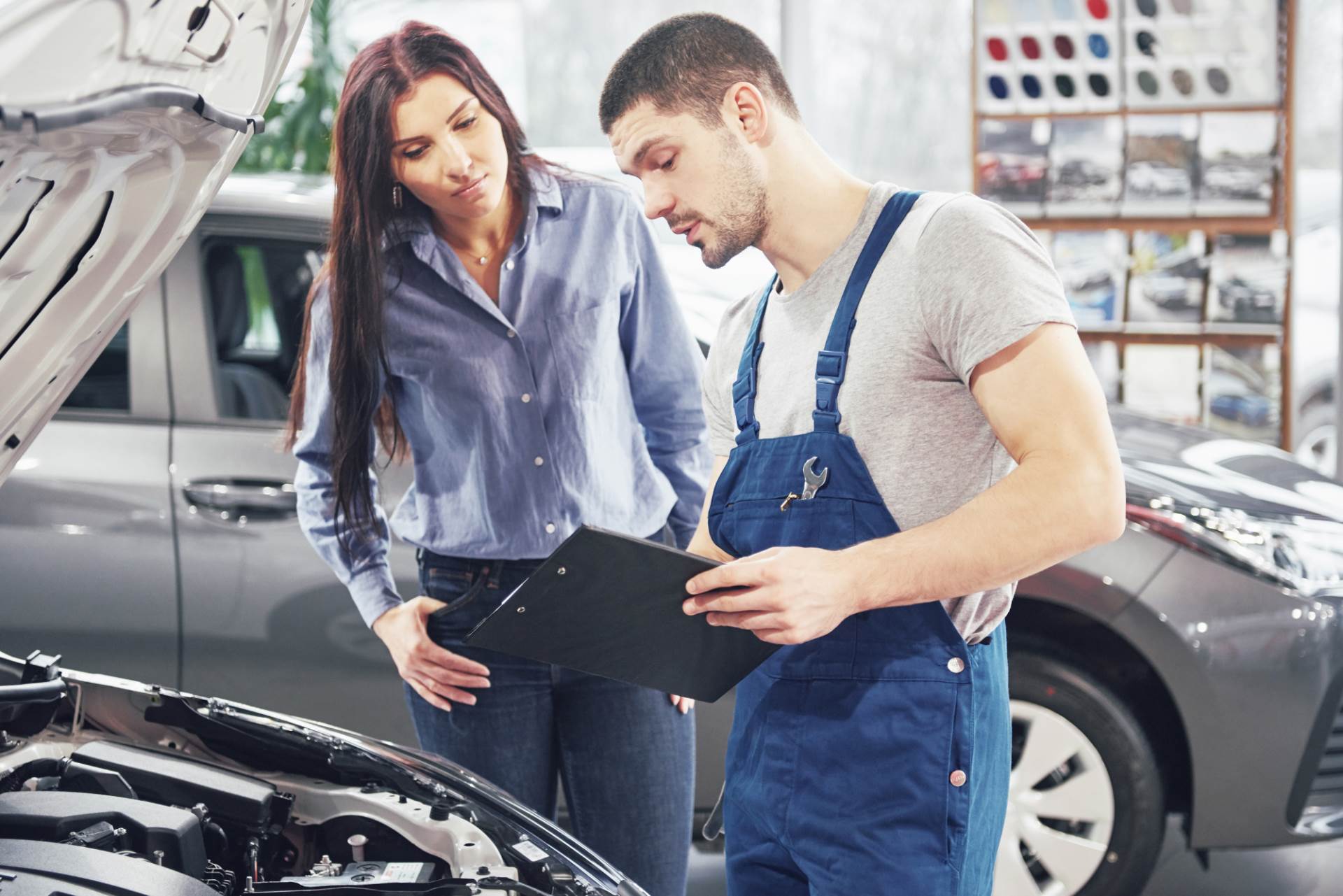 man-mechanic-woman-customer-discussing-repairs-done-her-vehicle