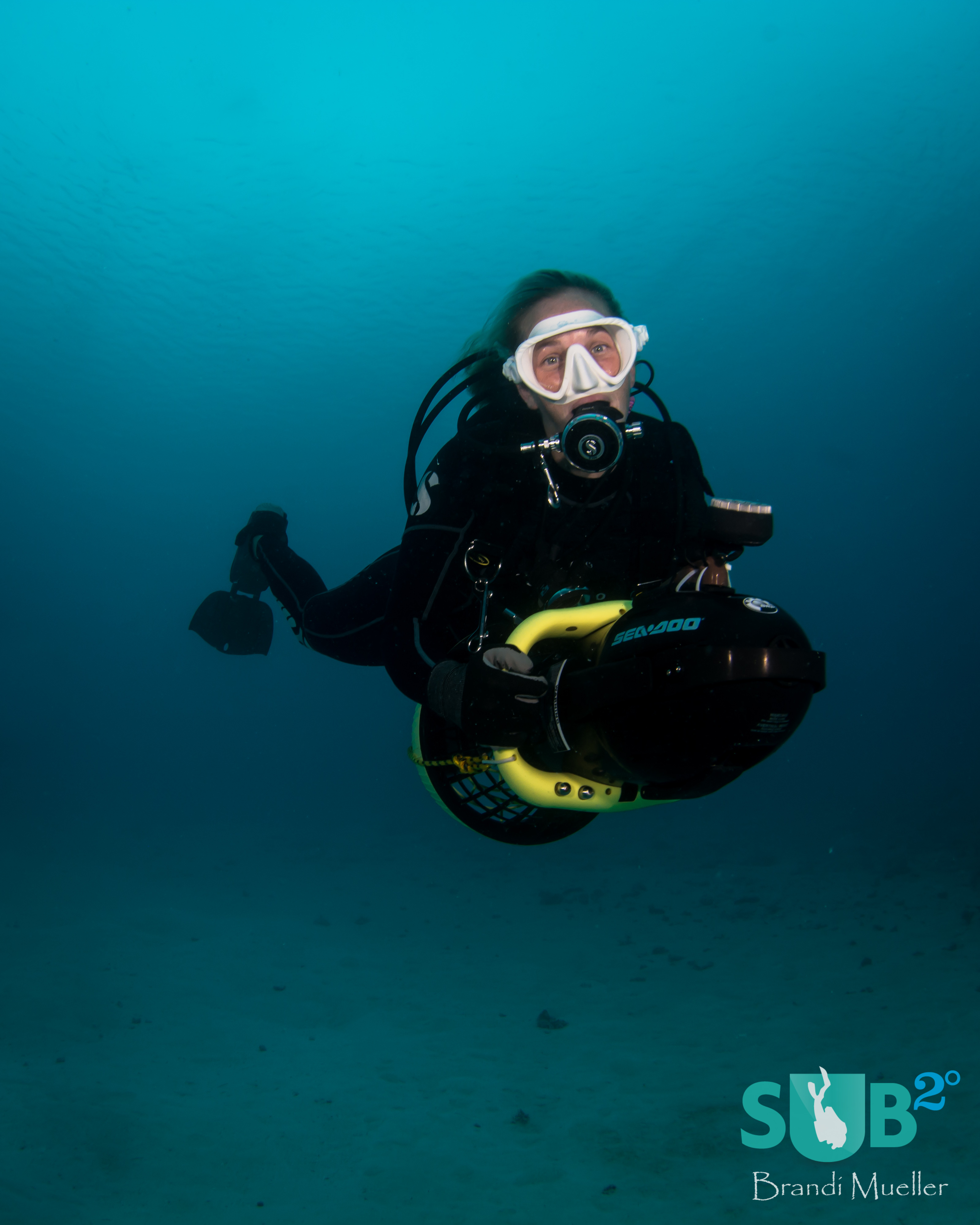 A diver zooms around a dive site on her DPV.